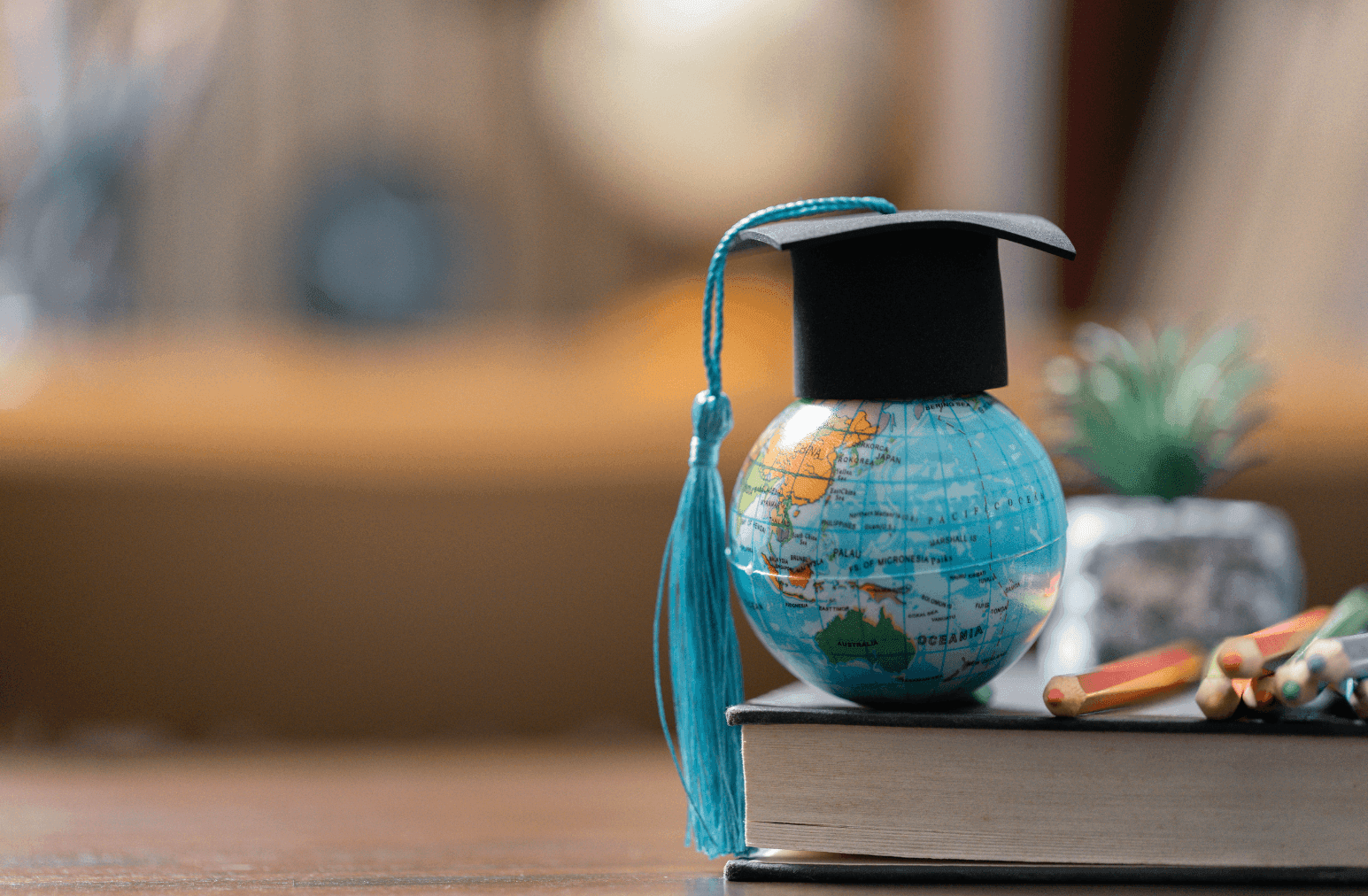 Image of globe depicting planet Earth with a black graduation cap